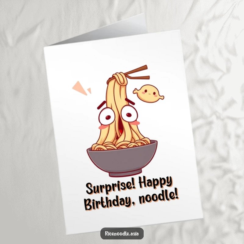 Funny Free Printable Noodle Birthday Card: A surprised noodle character with wide eyes, comically startled by a flying dumpling.