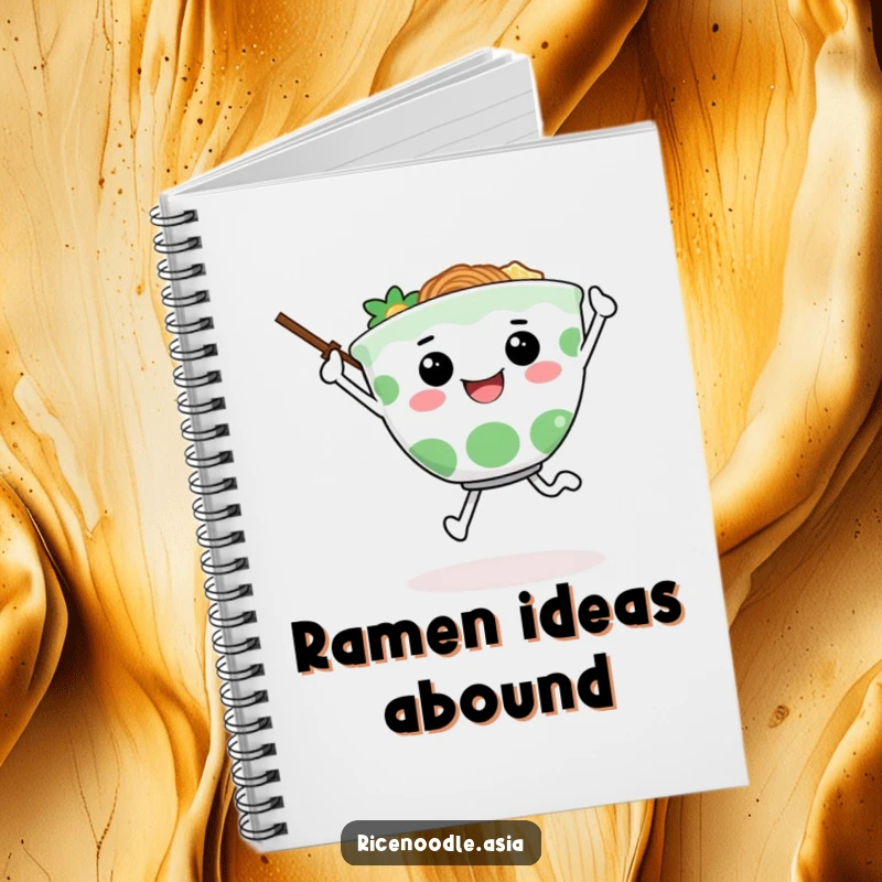 Funny notebook with a happy ramen bowl character joyfully skipping on the cover, chopsticks for arms, ready for your notes.
